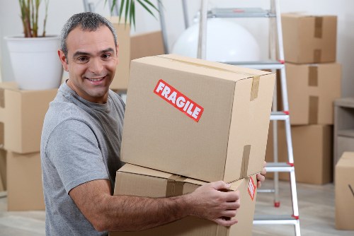 Furniture pick-up service removing a sofa in Northkensington