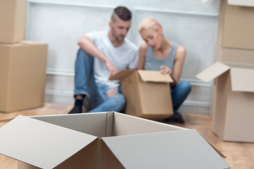 Removal team loading household items into a moving vehicle