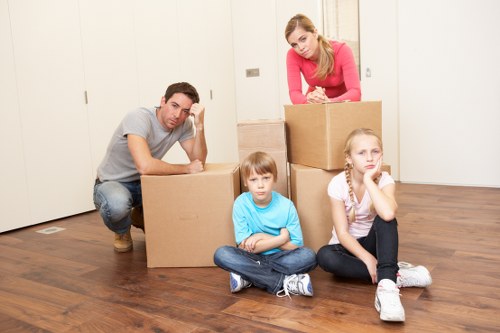 Moving team handling furniture and boxes during a North Kensington flat removal