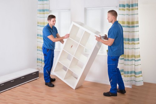 Staff carrying a sofa through a property doorway
