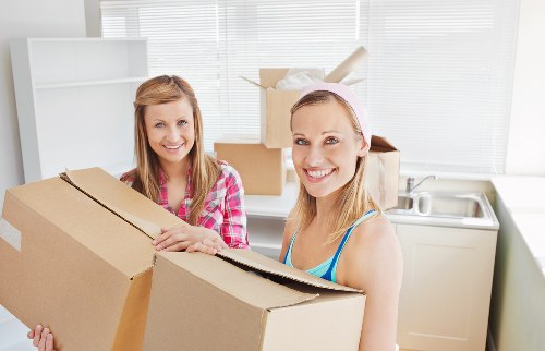 A local moving team handling furniture in North Kensington