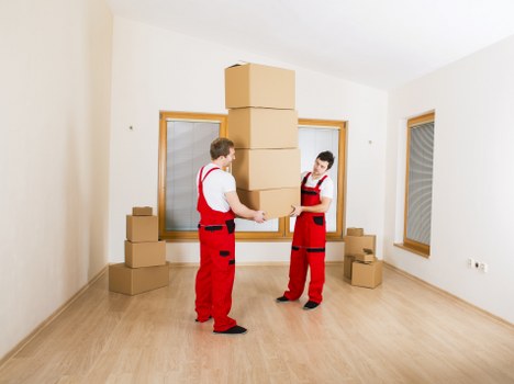 Moving team handling furniture and boxes in Northkensington