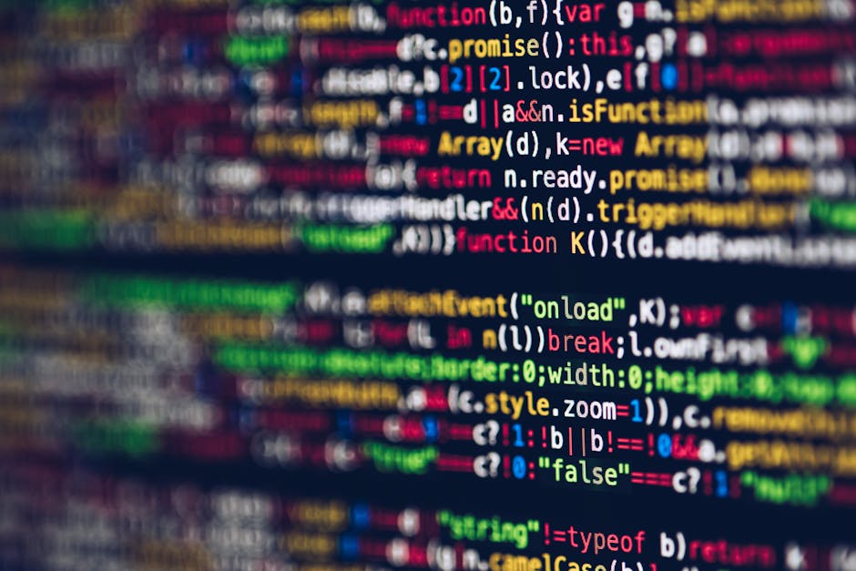 Close-up view of a computer screen displaying multicoloured programming code in various lines, including keywords like 'function', 'event', and 'return', with some parts blurred to indicate focus on t